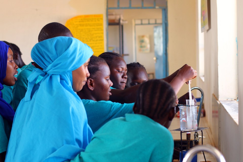 Students at Morneau Shepell Secondary School for Girls crowd around a Bunsen burner during a chemistry lab. The school spends $700 per pupil each year—about $550 more than other secondary schools in the camp— yet still doesn’t have enough textbooks and supplies to go around.