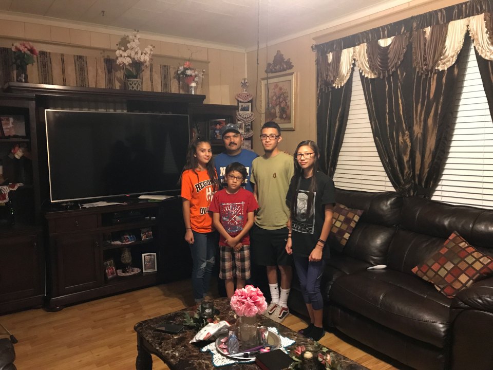 Hermenegildo Rubio stands with his children (from left) Abby, 16, Adam, 10, Danny, 20, and Noemi, 13, in the living room of his Honey Grove home.